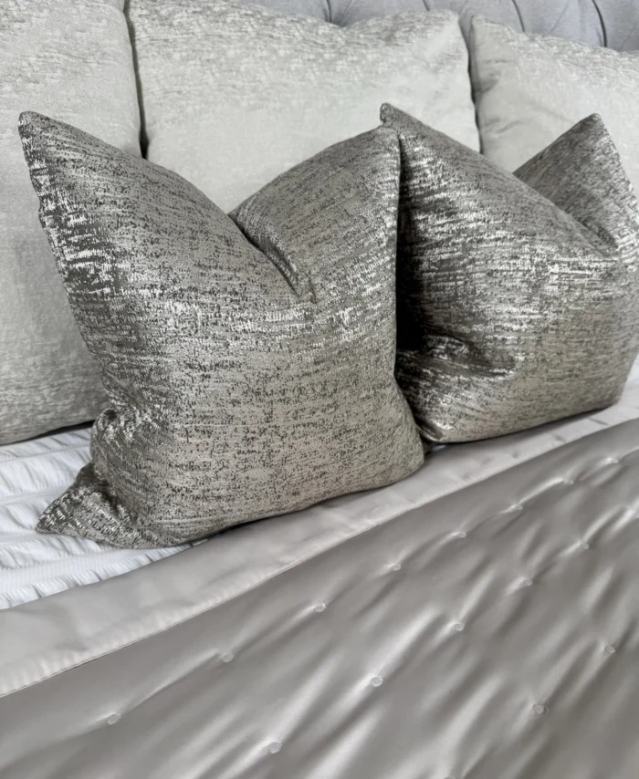 grey luxury cushion cover on a neatly laid bed